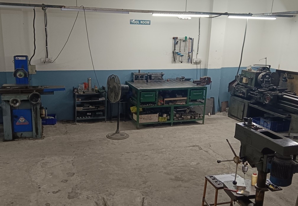 In house tool room with surface grinding and lathe machines for die maintenance.